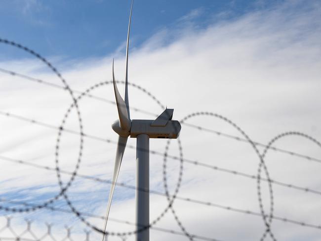 A wind turbine manufactured by Vestas Wind Systems A/S stands behind a razor wire fence at the Macarthur Wind Farm, a joint venture between AGL Energy Ltd. and Meridian Energy Ltd., near Macarthur, Victoria, Australia, on Friday, April 12, 2013. Sydney-based AGL's A$1 billion Macarthur project is the largest wind farm in the Southern Hemisphere. Photographer: Carla Gottgens/Bloomberg via Getty Images