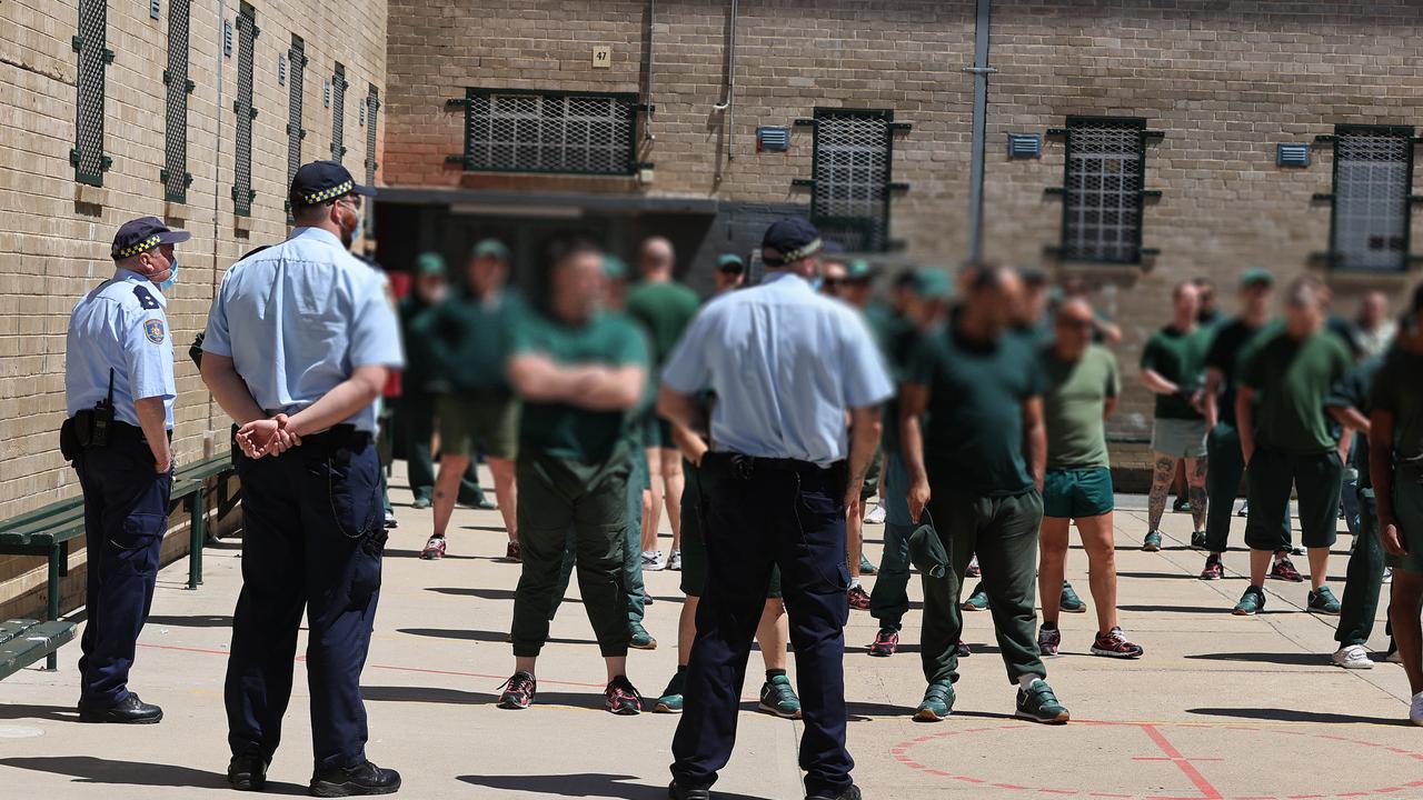 Correctional officers with inmates in the prisons yard area. Picture: Gary Ramage