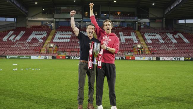 Wrexham co-owners Rob McElhenney and Ryan Reynolds, who are bringing Wrexham to Sydney in July, celebrate the club’s promotion to the second tier of British football last month. Picture: AP