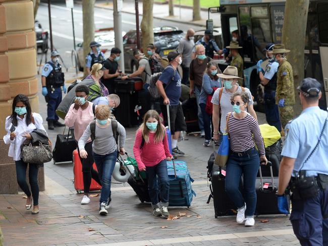 Returning overseas travellers are ushered into the Intercontinental Hotel for the beginning of their 14-day imposed quarantine. Picture: AAP