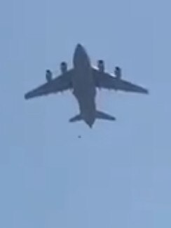 A person appears to fall from the plane.