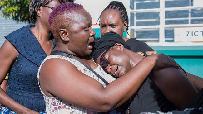 Florence Nyirenda, right, mother of Zambian student Lemekhani Nyireda, is consoled by relatives as his coffin arrives at Lusaka airport. Picture: AFP