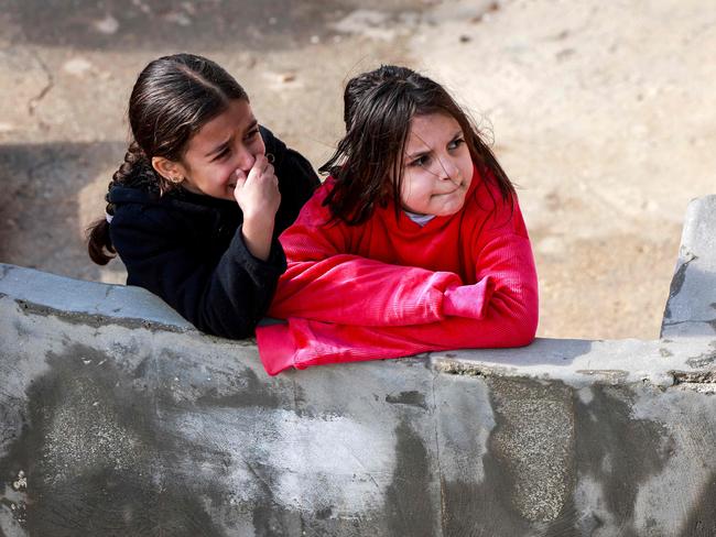 Young relatives look on as the body of a Palestinian man is carried by relatives during his funeral in the town of Silwad, north of Ramallah. Picture: AFP