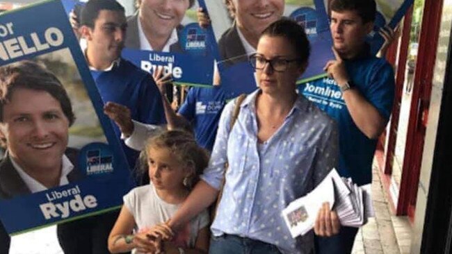 Karen Laxale, wife of Labor candidate Jerome Laxale, is surrounded by supporters of Ryde Liberal MP Victor Dominello at Eastwood on Saturday, March 9.