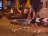 BIZARRE footage has captured a Victoria Police officer going for a late-night spin while sitting in a trolley. , Picture: Instagram