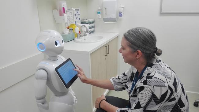 Manager of QUT Health Clinics Lisa Morgan and Pepper the robot. Picture: ARC Centre of Excellence for Robotic Vision