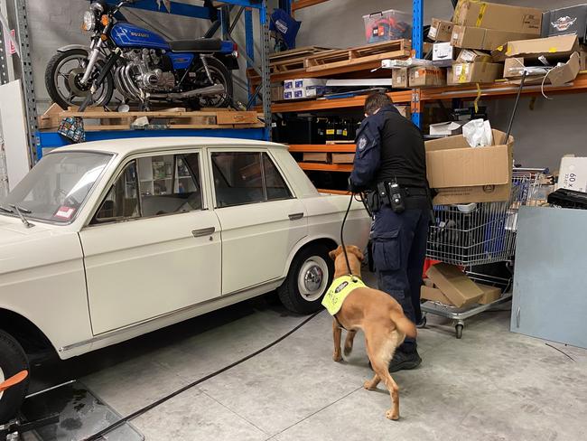 Police searching the warehouse which was full of vintage cars.