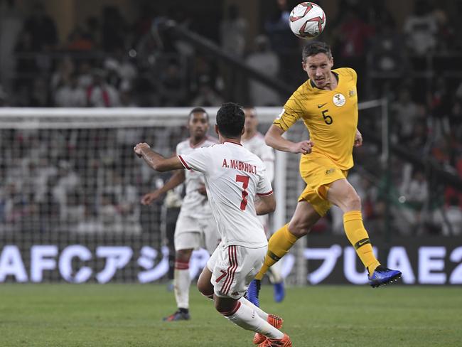 Australia's midfielder Mark Milligan vies for the ball with United Arab Emirates' forward Ali Mabkhout al Hajeri during the AFC Asian Cup quarterfinal soccer match between United Arab Emirates and Australia at Hazza Bin Zayed Stadium in Al Ain, United Arab Emirates, Friday, Jan. 25, 2019. (AP Photo/Hassan Ammar)