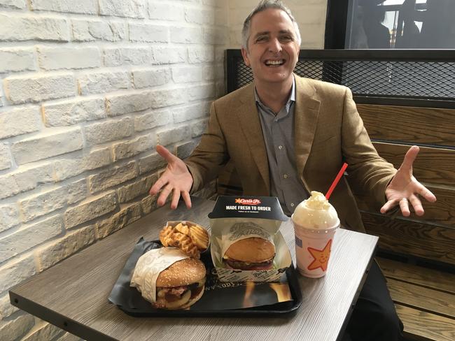 Jason Marker shows off some of the menu items at Carl’s Jr. Picture: Darren Cartwright/AAP