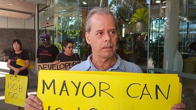 A group of eight protesters, including Geoff Holland, descended on the Spence St council chambers on Wednesday calling for Mayor Bob Manning to resign.