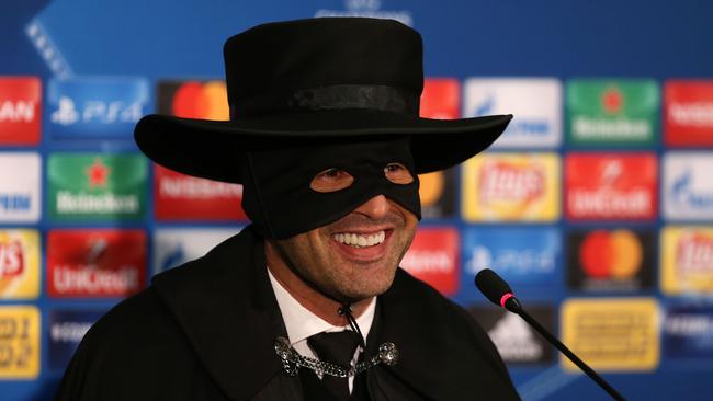 Shakhtar Donetsk's Portuguese manager Paulo Fonseca, wearing a Zorro mask and hat, delivers a press conference.