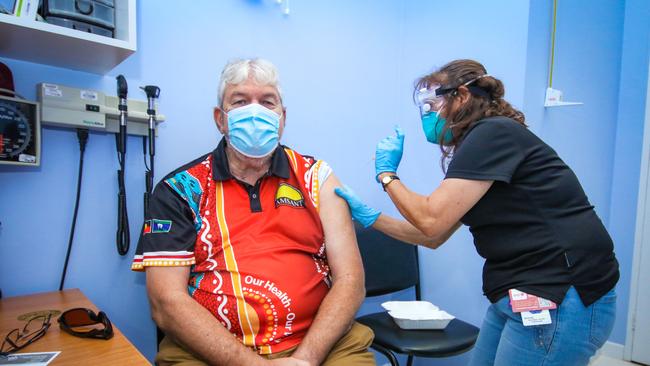 Local Indigenous Leader John Paterson getting his booster shot from Aboriginal Health Practitioner Brenda Martin-Jard at the Danila Dilba facility in Palmerston. Picture: Glenn Campbell