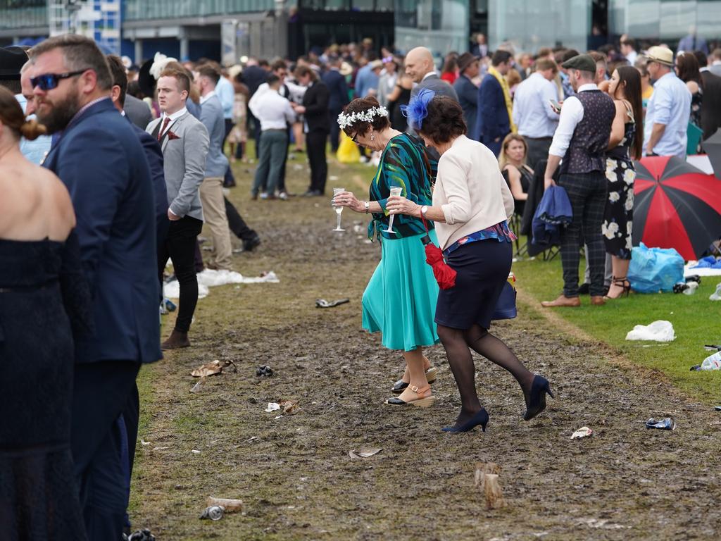 Racegoers are seen in the late afternoon on Melbourne Cup day during the Lexus Melbourne Cup Day, as part of the Melbourne Cup Carnival, at Flemington Racecourse in Melbourne, Tuesday, November 6, 2018. (AAP Image/Stefan Postles) NO ARCHIVING, EDITORIAL USE ONLY