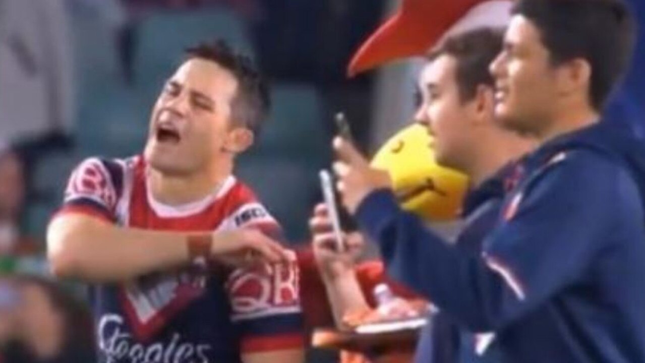 Rocky the Rooster whacks Cooper Cronk on his injured shoulder.