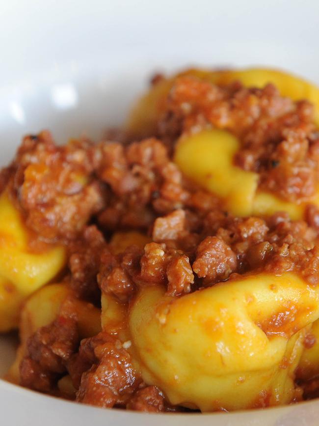 Cappelletti al raguû — traditional cheese filled pasta with Bolognese sauce.