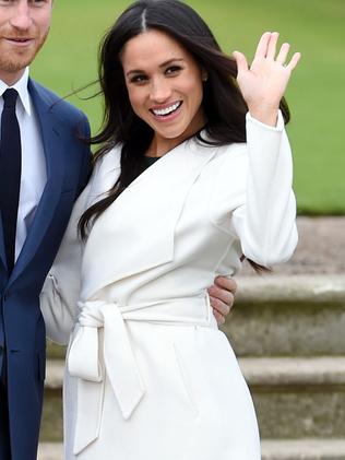 Meghan waves to photographers. Picture: Eddie Mulholland/Pool via AP