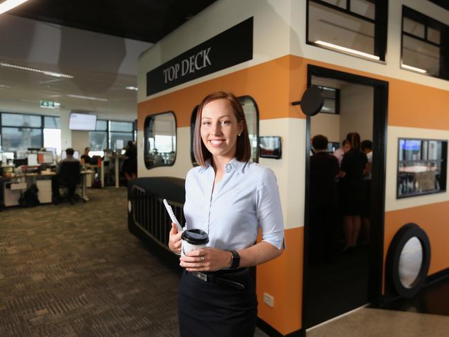 Flight Centre Travel Group’s Sam Aldenton passes a bus-shaped meeting room. Picture: Jono Searle