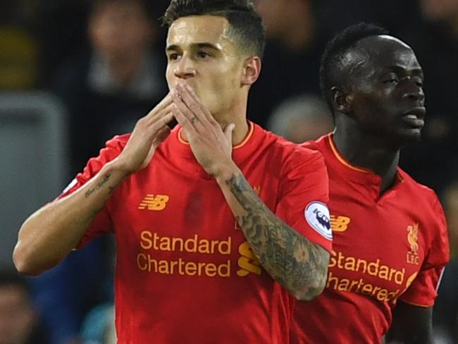 Liverpool's Brazilian midfielder Philippe Coutinho (L) celebrates scoring their second goal with Liverpool's Senegalese midfielder Sadio Mane (R) during the English Premier League football match between Liverpool and West Bromwich Albion at Anfield in Liverpool, north west England on September 10, 2016. / AFP PHOTO / PAUL ELLIS / RESTRICTED TO EDITORIAL USE. No use with unauthorized audio, video, data, fixture lists, club/league logos or 'live' services. Online in-match use limited to 75 images, no video emulation. No use in betting, games or single club/league/player publications. /