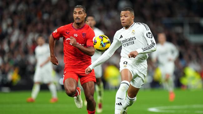 Kylian Mbappe of Real Madrid runs with the ball under pressure from Loic Bade of Sevilla FC. DAZN has global streaming rights for Spain’s LaLiga. Picture: Getty Images