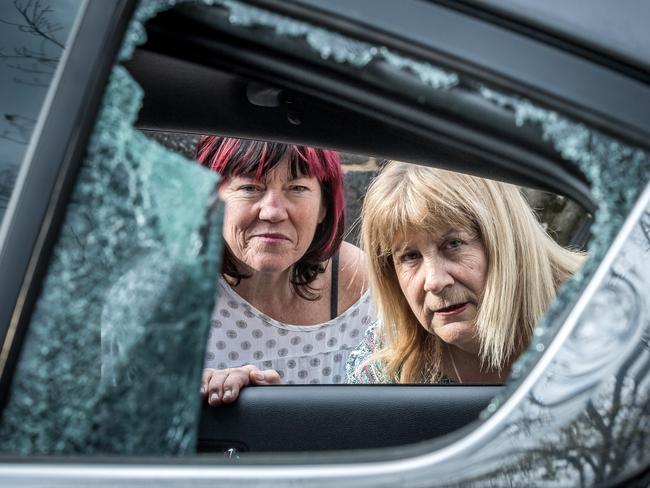 Victims Leigh Mahady and Julie Dougherty look through the smashed window of the Kia Leigh was driving during the incident. Picture: Jake Nowakowski