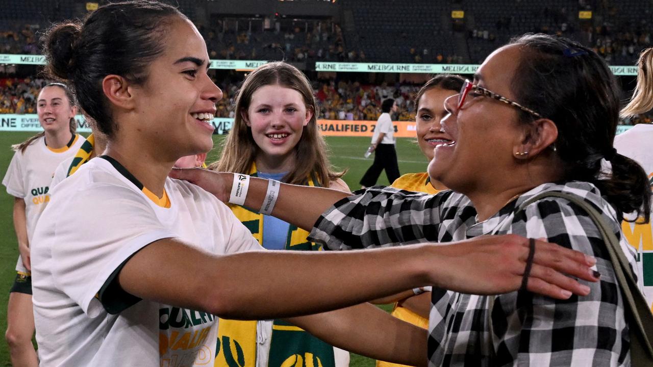 Mary Fowler is congratulated by Australian Olympic champion Cathy Freeman after the Matildas secured qualification for the Paris Games with the 10-0 win over Uzbekistan at Marvel Stadium. Picture: William WEST / AFP