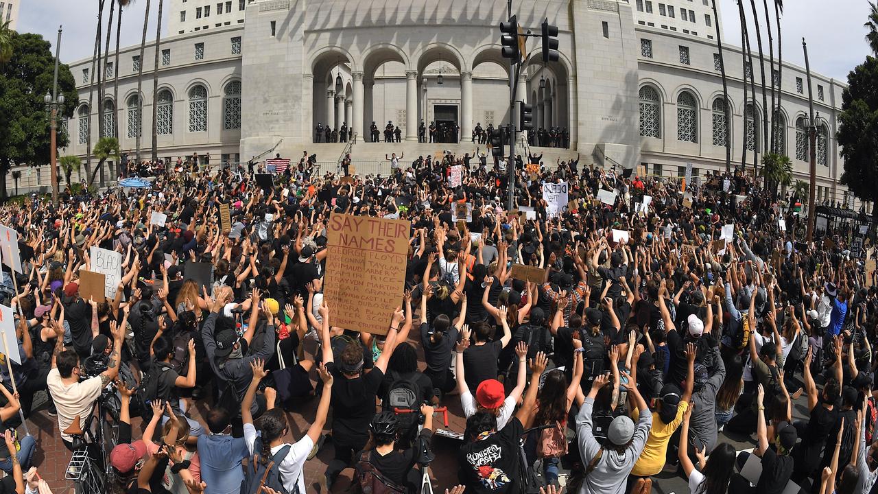 Demonstrators kneel in front of Los Angeles City Hall with their hands up during a protest Tuesday, June 2, 2020, in Los Angeles, US, over the death of George Floyd. Picture: AP