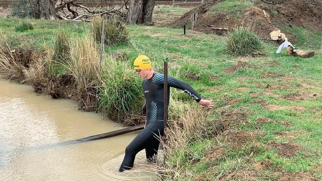 Col Pearse takes a dip in the muddy waters of his family’s dam to keep in shape for next year’s Paralympics.