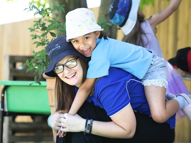 Courtney Cole poses with kindergarten child Kaci Daya, 5,  at Nottingham World of Learning in Calamvale, Brisbane on Wednesday, October 23, 2019. Major childcare provider G8 has launched a new scholarship program to give its early childhood educators $15k to complete their Bachelor's degree. (AAP Image/Claudia Baxter)