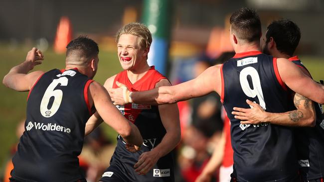 The Casey Demons celebrate their victory in the preliminary final.