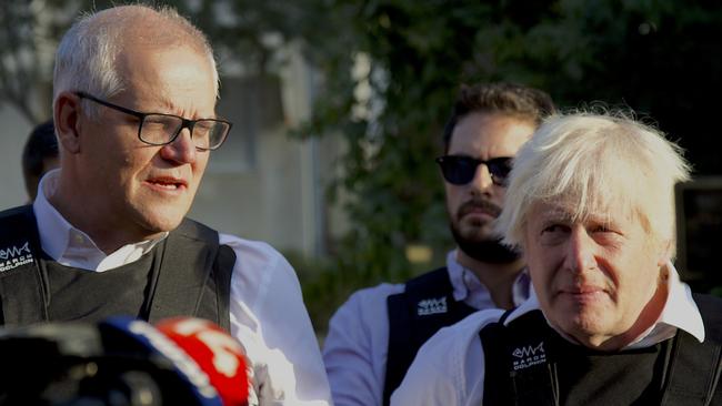 Mr Morrison with former British leader Boris Johnson giving a press conference in Kfar Aza. Picture: Yoni Bashan