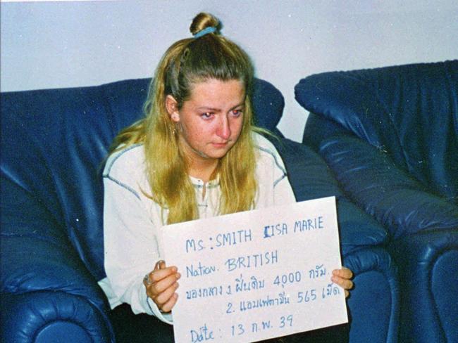 Lisa Marie Smith then aged 20, holds a card bearing her name, nationality and charges of arrest at the Bangkok International Airport in February 1996. Picture: AP