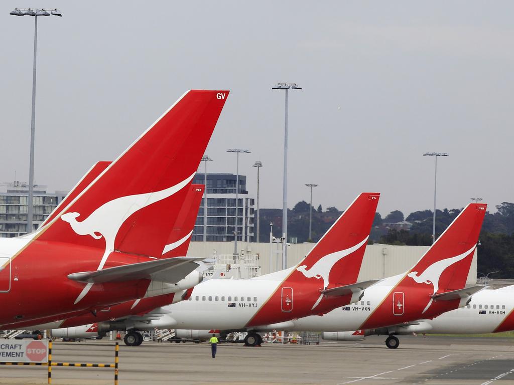 The tails of Qantas planes are lined up at Sydney Airport in Sydney, Sunday, Oct. 30, 2011. Qantas Airways grounded all of its aircraft around the world indefinitely Saturday due to ongoing strikes by its workers. (AP Photo/Rick Rycroft)