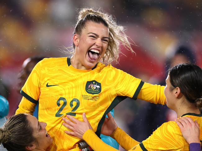 BRENTFORD, ENGLAND - APRIL 11: Charlotte Grant of Australia celebrates victory with teammates after defeating England during the Women's International Friendly match between England and Australia at Gtech Community Stadium on April 11, 2023 in Brentford, England. (Photo by Ryan Pierse/Getty Images)