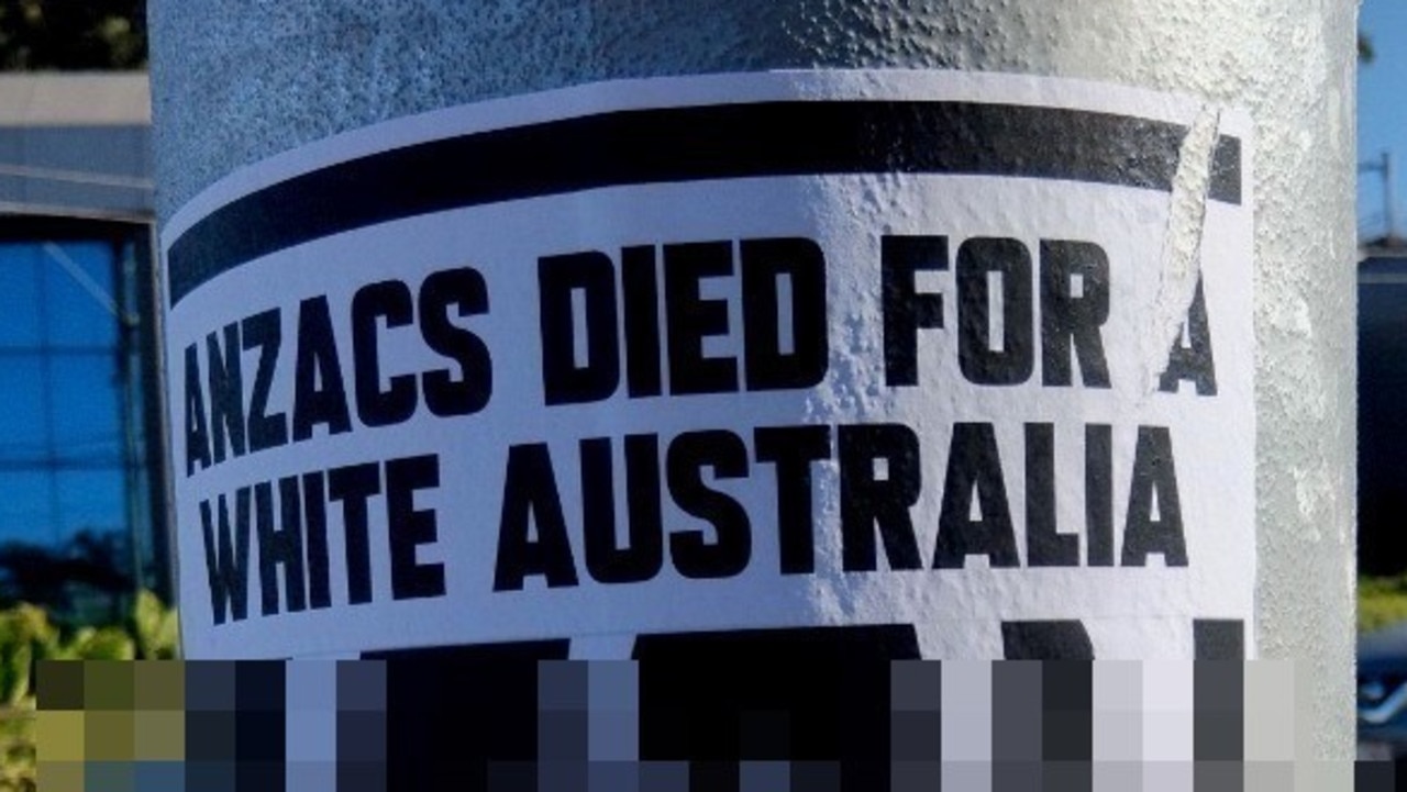 Police alerted after racist posters plastered at sites in inner Brisbane.