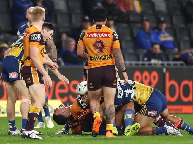 David Fifita screams as his leg is trapped in a tackle.