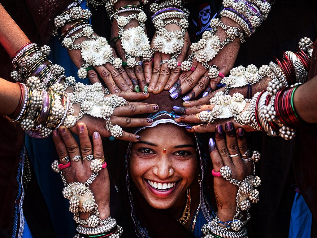 © Sanghamitra Sarkar, India, Entry, Open, Smile, 2016 Sony World Photography Awards “Tribal women of Gujrat in India wearing traditional silver ornaments and blessing a newly married girl.”