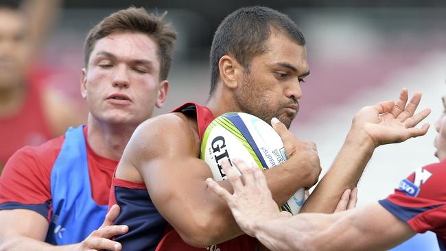 Karmichael Hunt takes on the defence.