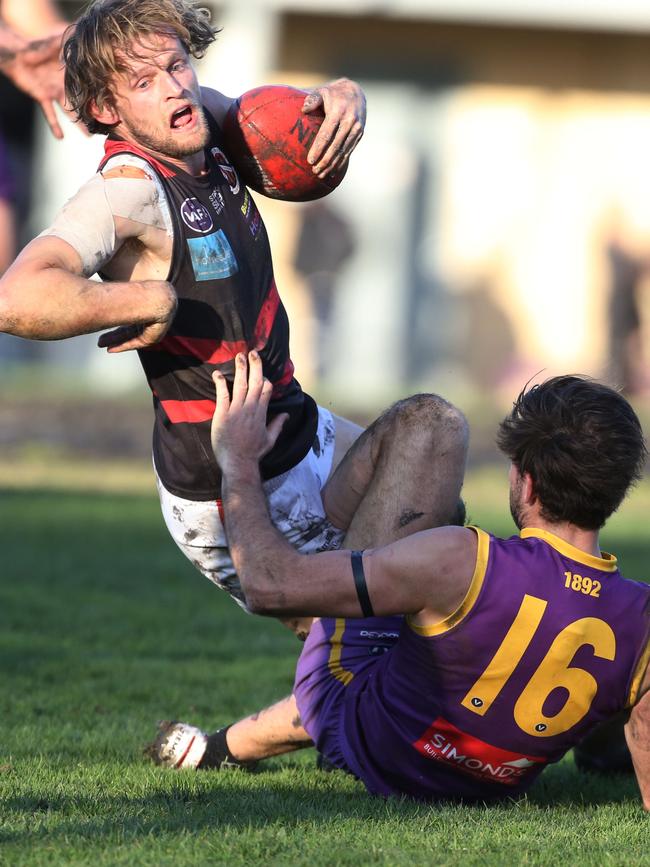 VAFA footy: Collegians v Old Xaverians - William Hams is tackled with the ball for Old Xaverians. Picture: Stuart Milligan