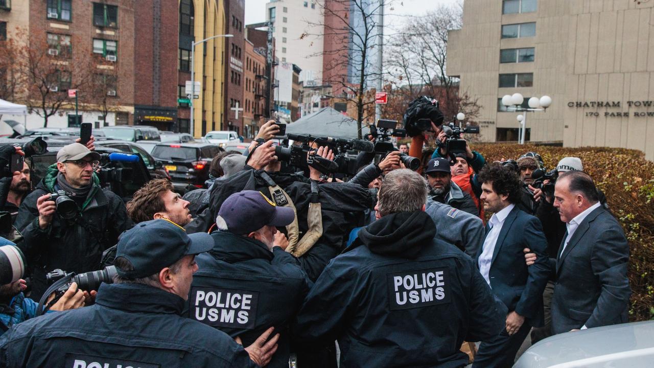 Sam Bankman-Fried, co-founder of FTX Cryptocurrency Derivatives Exchange, second right, departs from court in New York, US, on Thursday. Photographer: Stephen Yang/Bloomberg