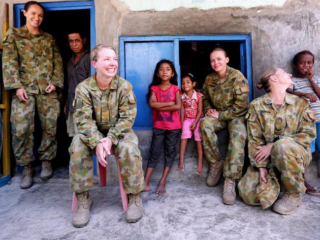 All smiles ... Australian soldiers SIG Kylie Grimes, CPL Kylie Collingwood, LCPL Peta Reeves and SIG Krystelle Watts in a local community in Dili, East Timor in 2013.