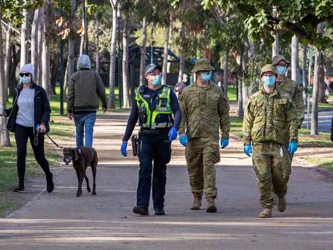 Defense Force personnel and Protective Services Officers patrolling at the Tan running track. Picture: Getty Images