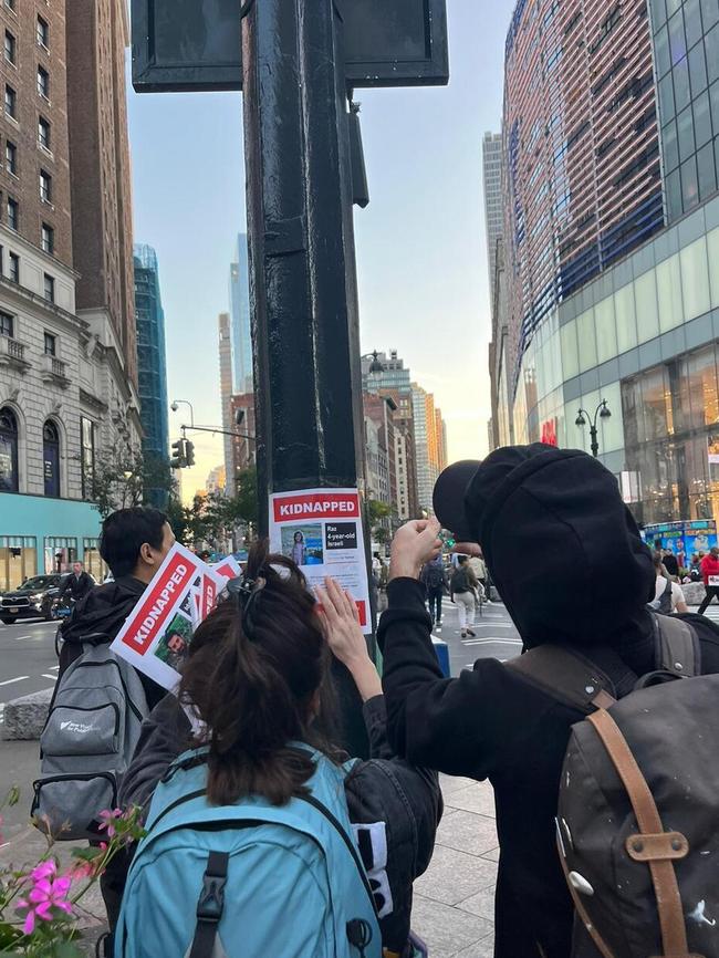 Nitzan Mintz and Dede Bandaid hanging hostage posters in New York City. Picture: Mor Shani