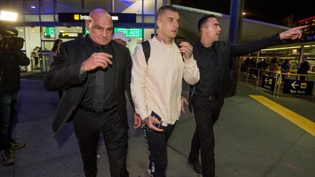 Dustin Martin arrives back from New Zealand at Tullamarine International.