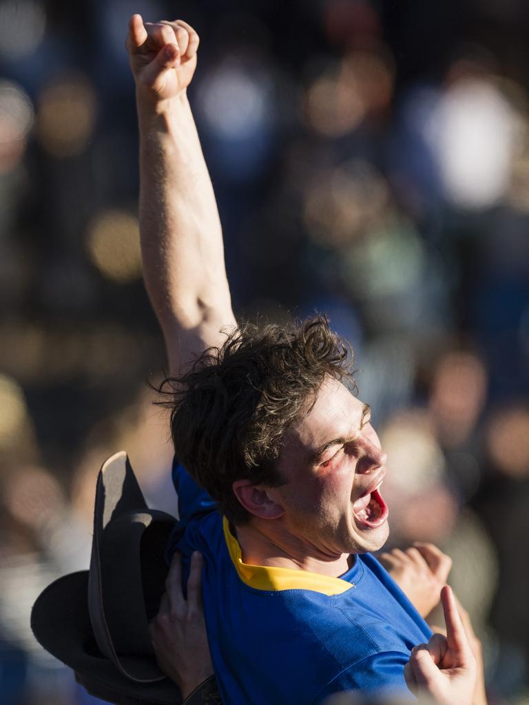 Grammar captain George Griffiths is lifted by students in celebration after TGS defeat Downlands to claim the O'Callaghan Cup.