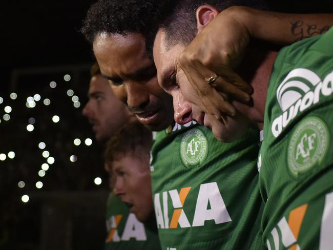 Players of Brazil's Chapecoense football club participate in a tribute to their fellow players killed in a plane crash Monday night in Colombia, at the club's stadium in Chapeco, Santa Catarina, Brazil, on November 30, 2016. Fans mourned Wednesday for a Brazilian football team decimated in a plane crash that killed 71 people in Colombia, as a recording emerged of the panicked pilot reporting he was out of fuel. / AFP PHOTO / DOUGLAS MAGNO