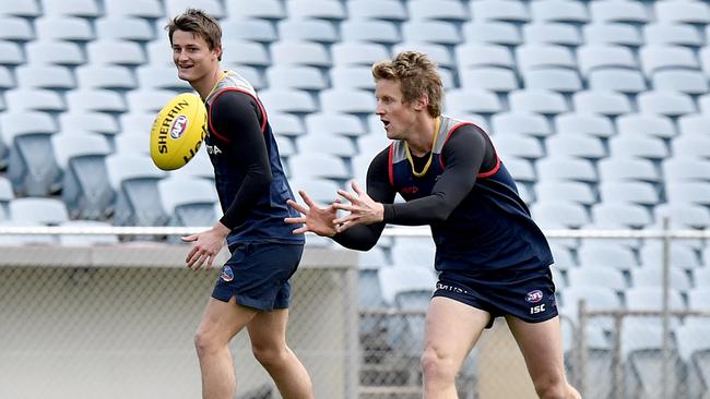 Crow Matt Crouch, left, should only benefit from the return of star teammate Rory Sloane, right,