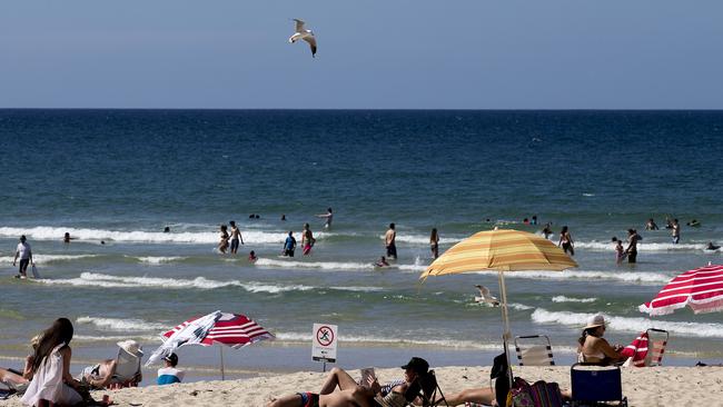 People enjoying the sun and sand at Burleigh Beach: Holidaymaker traffic is adding to the city’s traffic woes. Photo: Jerad Williams