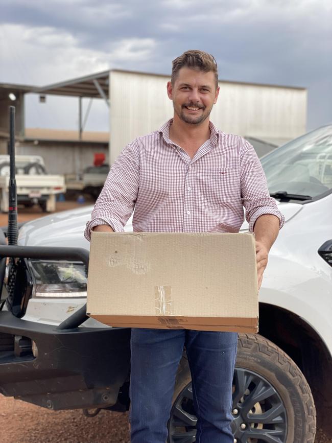 Northern Territory Cattlemen’s Association chief executive Will Evans delivers Covid tests.