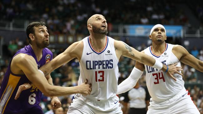 Andrew Bogut and Marcin Gortat battle for the rebound. Picture: AFP