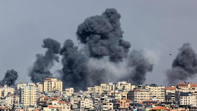 Smoke rises over Gaza City during Israeli air strike. Palestinian militants have begun a "war" against Israel. Picture: AFP